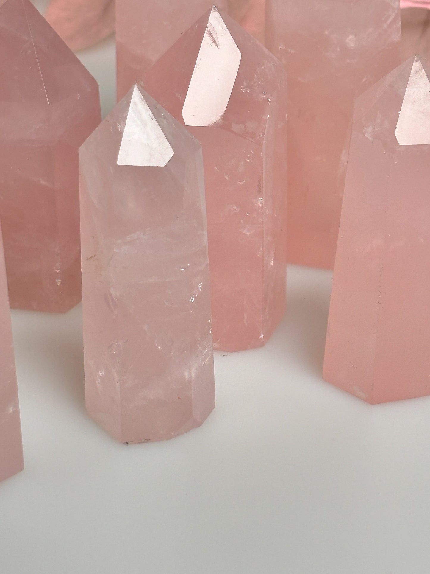 Beautiful rose quartz towers with rainbows - healing crystal for love and harmony, natural stone decoration