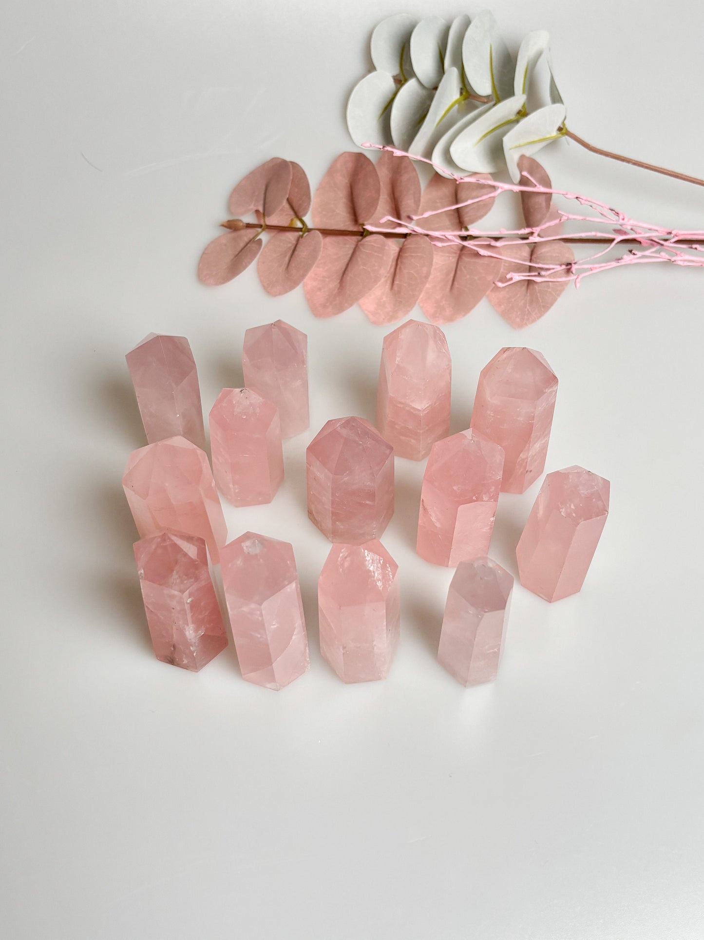 Beautiful rose quartz towers with rainbows - healing crystal for love and harmony, natural stone decoration