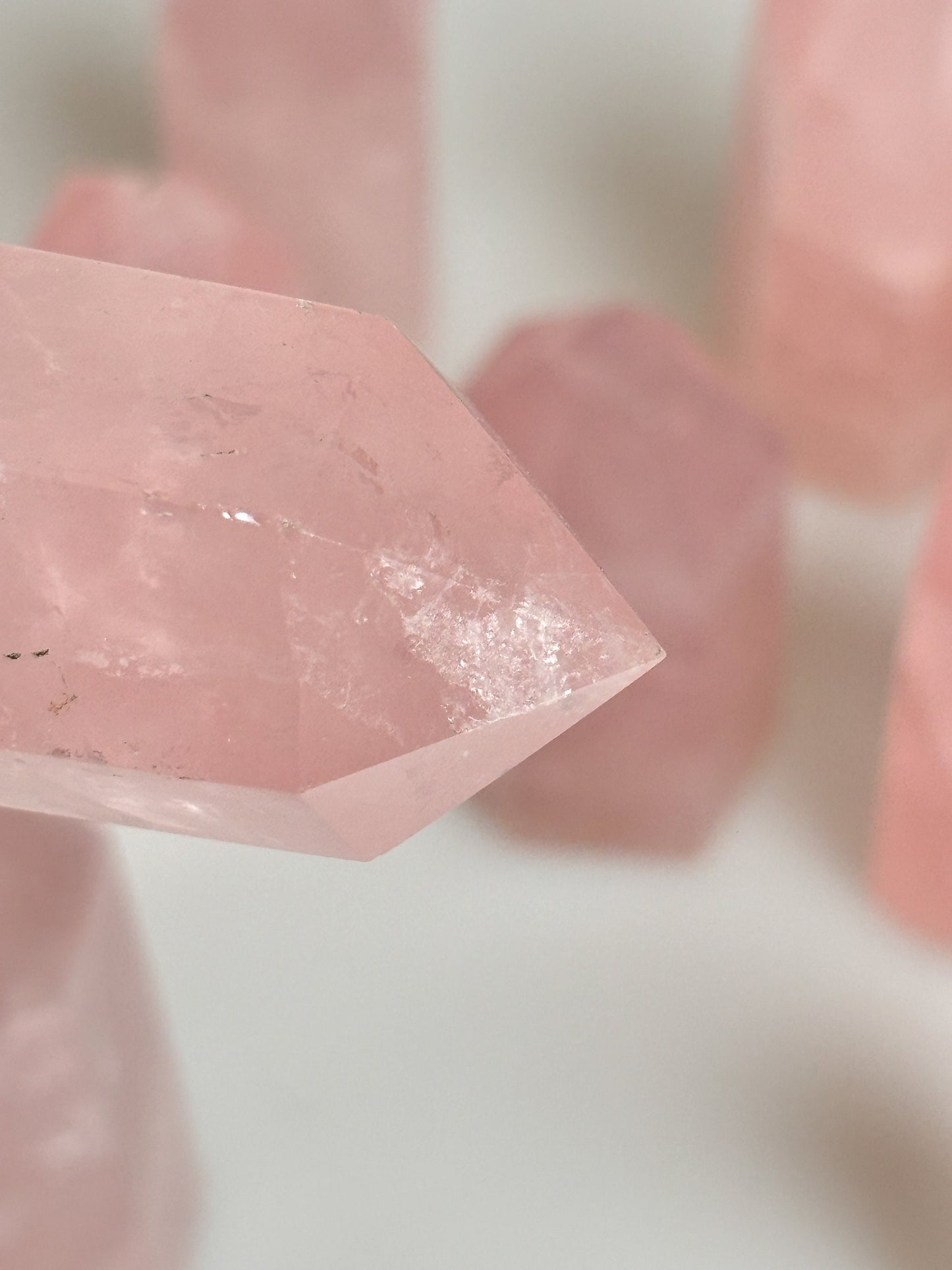 Beautiful rose quartz towers with rainbows - healing crystal for love and harmony, natural stone decoration