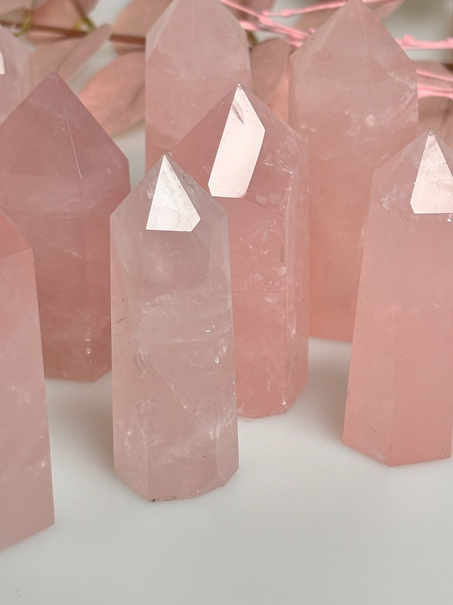 Beautiful rose quartz towers with rainbows - healing crystal for love and harmony, natural stone decoration